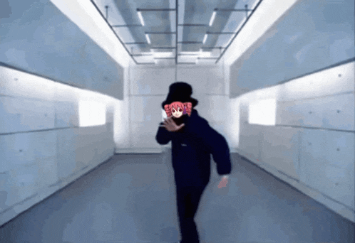 a person in a top hat is dancing in a room
