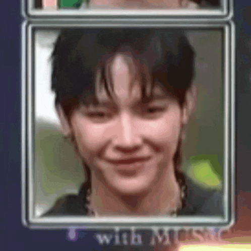a close up of a man 's face in a frame with a smile on his face .