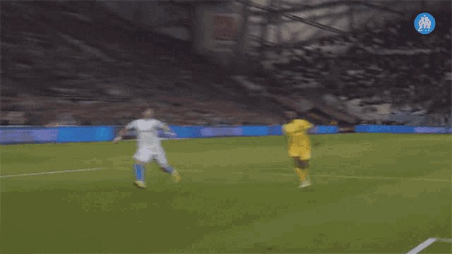 a blurry picture of a soccer field with a blue circle that says om on it