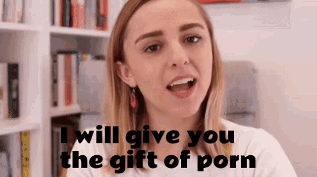 a woman says " i will give you the gift of porn " in front of a bookshelf