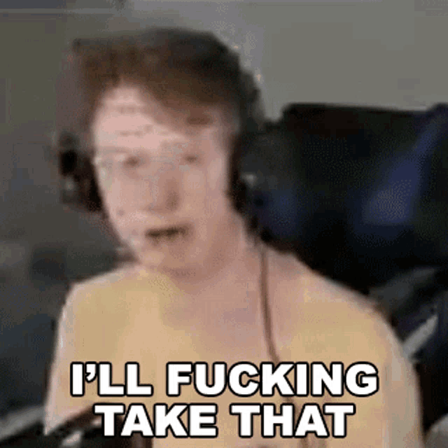 a man wearing headphones is sitting in front of a microphone and saying `` i 'll fucking take that '' .