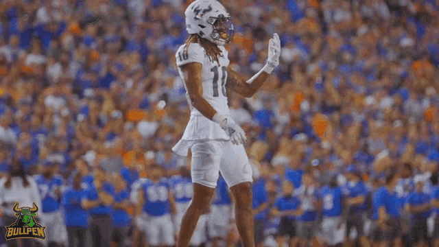 a football player in a white uniform with the number 11 on it