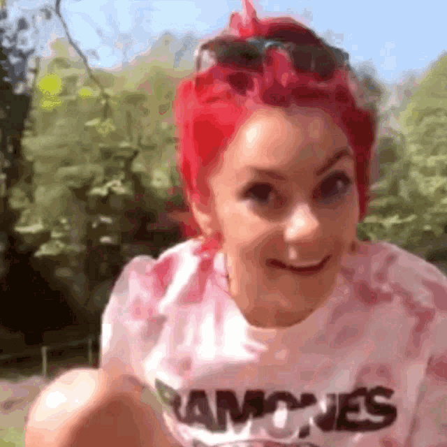 a woman with red hair wearing a ramones shirt