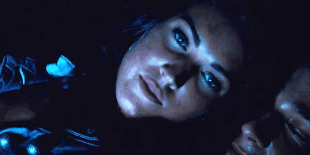 a close up of a woman laying next to a man