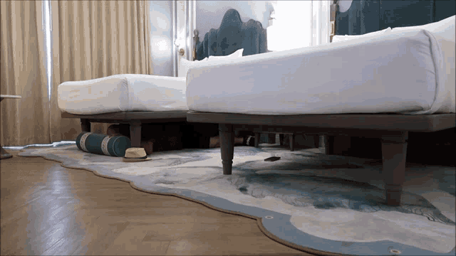 a hotel room with two beds and a rug that looks like an iceberg