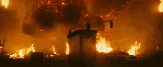 a city is on fire and a large object is flying through the air