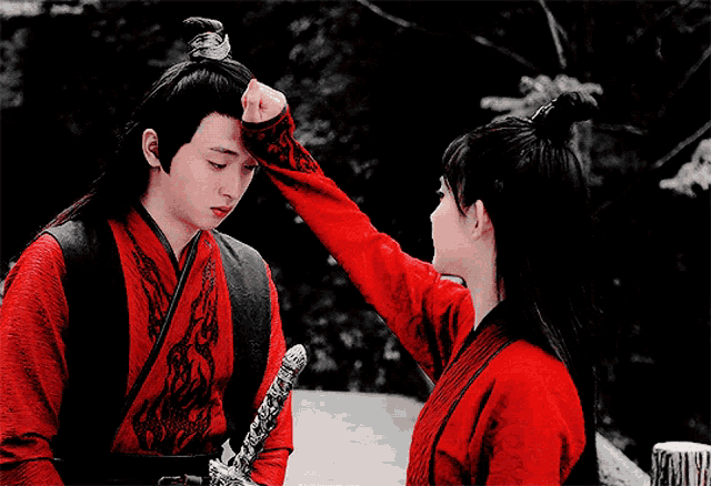 a man in a red shirt is being touched by a woman in a red shirt
