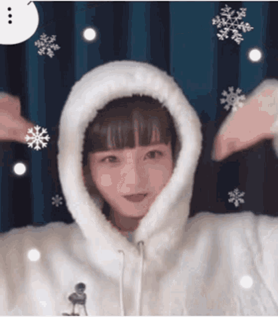 a girl wearing a white furry hoodie with snowflakes around her