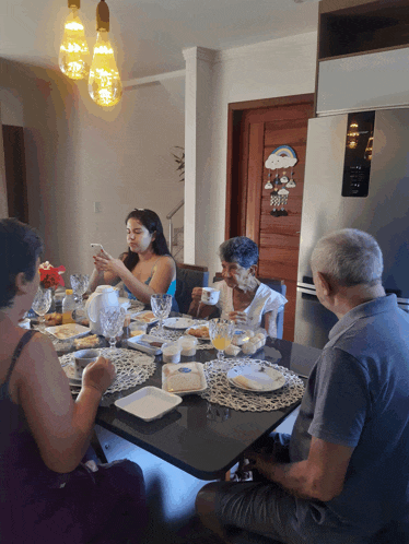 a group of people sitting around a table with a snoopy door behind them
