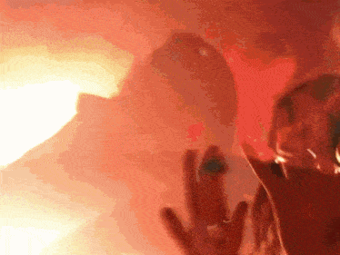 a close up of a person 's hands with a red background