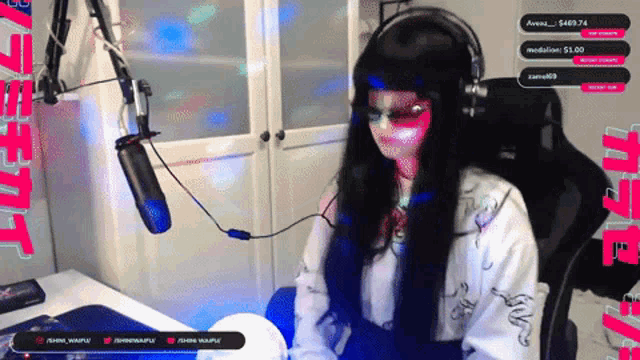 a woman wearing headphones is sitting in front of a microphone in a room