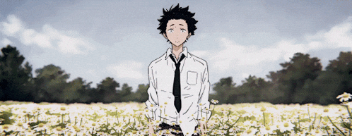 a man in a tie is standing in a field of flowers