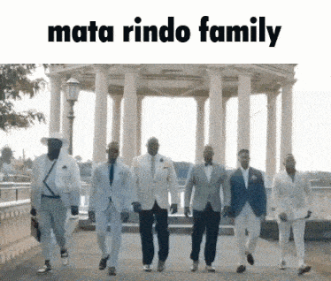a group of men in suits are walking in a line with the words mata rindo family written above them