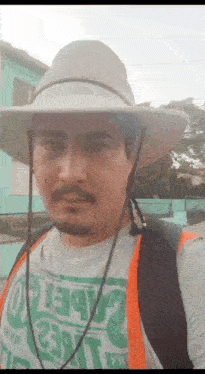 a man wearing a hat and a t-shirt that says ' 2 ' on it