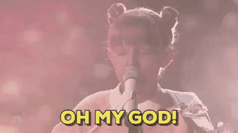 a little girl is singing into a microphone and saying `` oh my god '' .