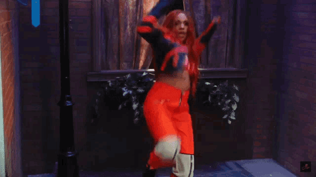 a woman in a superhero costume is doing a split