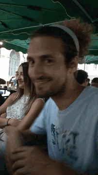 a man wearing a blue shirt that says ' abercrombie & fitch ' on the front