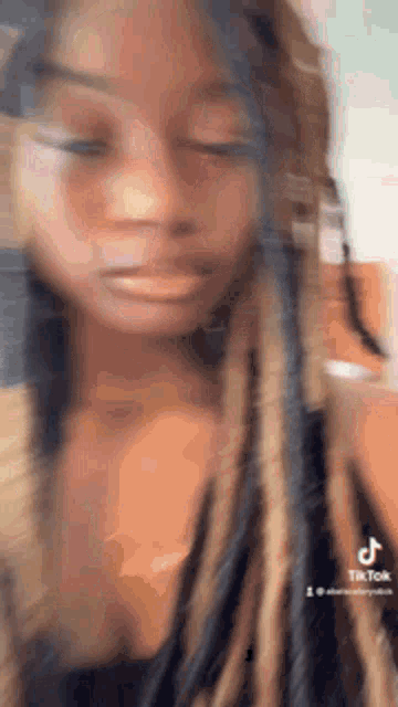 a close up of a woman 's face with a blurry background .
