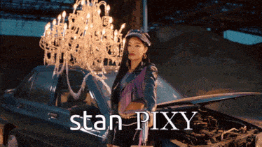 a woman is standing next to a car with the word stan pixy on it