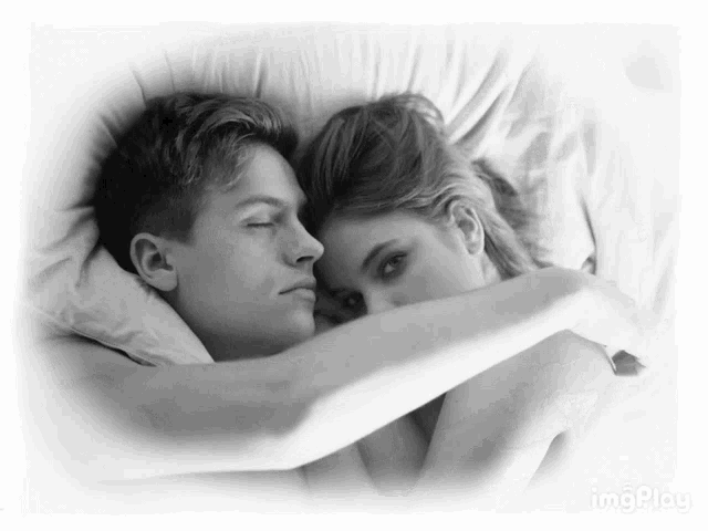 a black and white photo of a man and a woman hugging each other