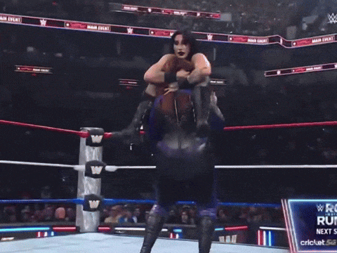 a wrestling match is being shown on a television screen