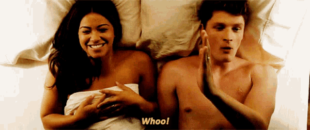 a man and a woman are laying on a bed and the man says " whool "