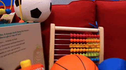 a box that says kids & keeps kids busy for hours sits next to a basketball and an abacus