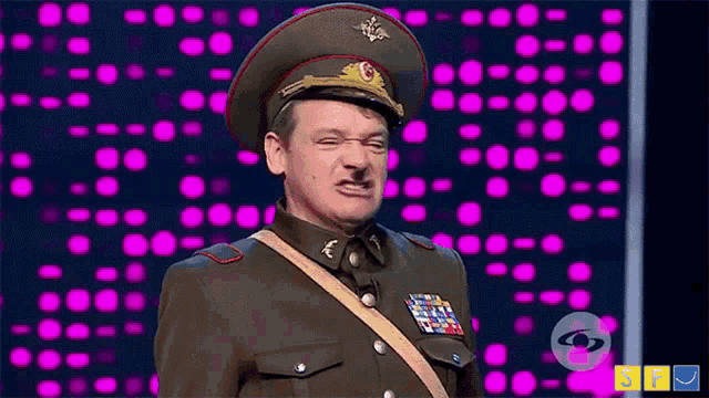 a man in a military uniform making a face