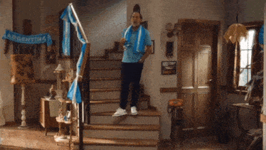a man stands on a set of stairs with a banner that says argentina