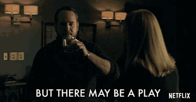 a man drinking a glass of whiskey next to a woman with the words but there may be a play netflix