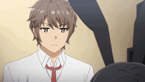 a man in a white shirt and red tie looks angry