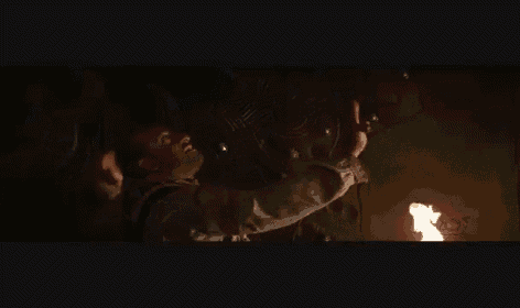 a man is standing in a dark room holding a torch .