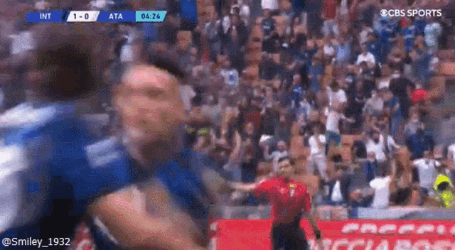 a soccer player is being tackled by another player in a crowded stadium .