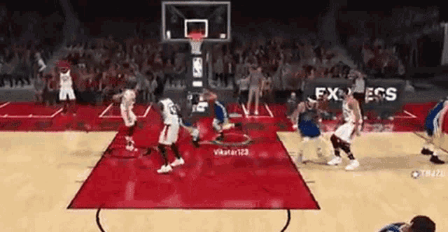 a group of basketball players are playing a game of basketball .