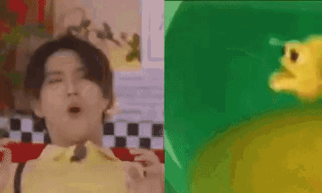 a man is eating a slice of pizza next to a green plate with a cartoon character on it