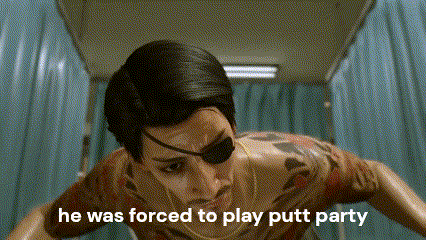 a man with a tattoo on his chest is wearing a blindfold and a necklace .