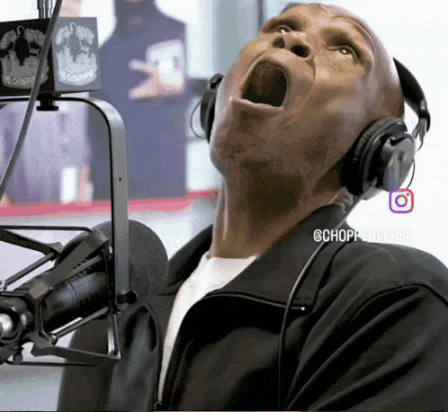 a man wearing headphones is singing into a microphone with the hashtag @chopradioverse