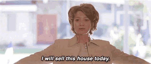 a woman is standing in front of a window with her arms outstretched and says `` i will sell this house today . ''