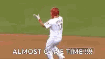 a baseball player wearing a phillies jersey is giving a thumbs up sign .