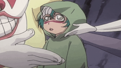 a child in a green hoodie is being touched by a white hand