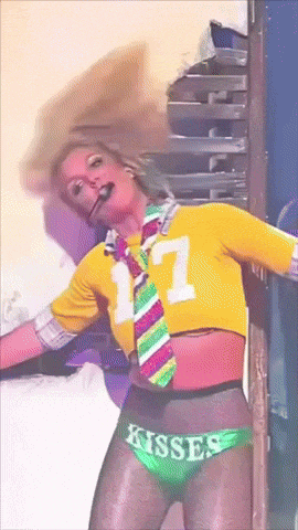 a woman wearing a yellow shirt with the number 17 on it and a tie