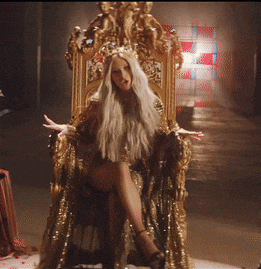 a woman with long blonde hair is sitting on a throne