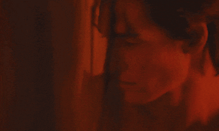a close up of a person 's face with a red background