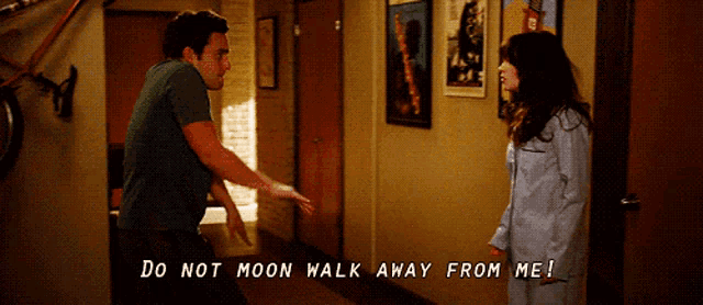 a man and a woman are standing in a hallway and the man is saying do not moon walk away from me