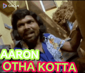 a man in a blue shirt with the words aaron otha kotta