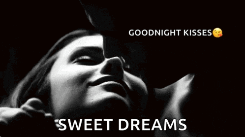 a man is kissing a woman on the cheek in a black and white photo with the words `` goodnight kisses sweet dreams '' .