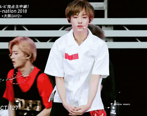 a man in a white shirt stands in front of a sign that says -nation 2018 on it