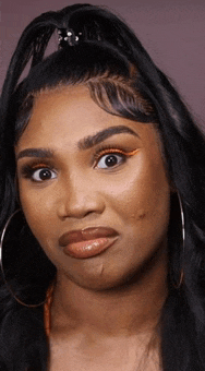 a woman with a ponytail and hoop earrings is making a funny face