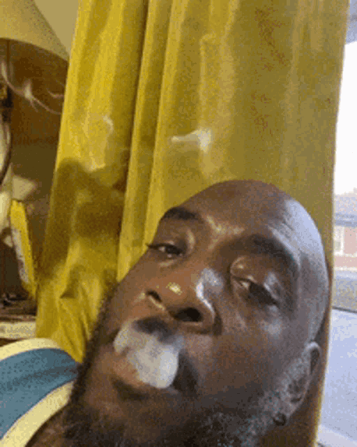 a man with a beard is smoking a cigarette