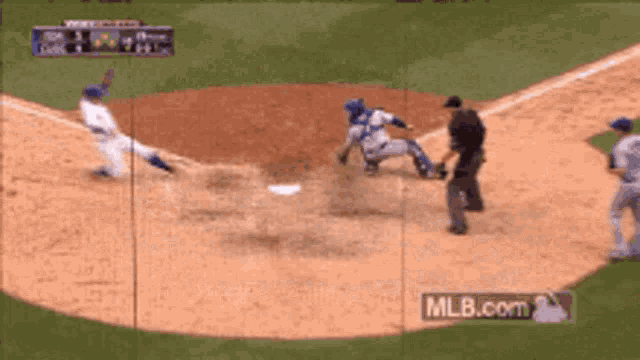 a baseball player is sliding into a base while a referee watches on mlb.com